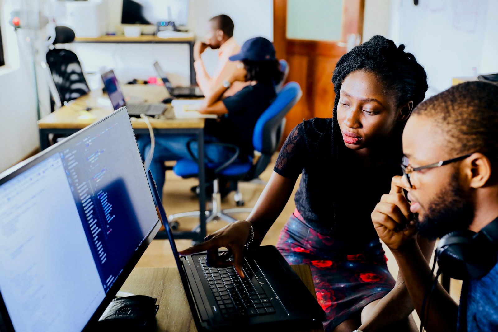 Two senior engineers pairing on production code at a shared desk
